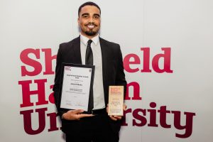 Photo of award winner holding certificate and trophy
