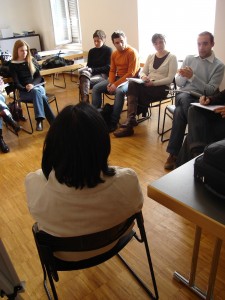 Photo of university group sitting around discussing
